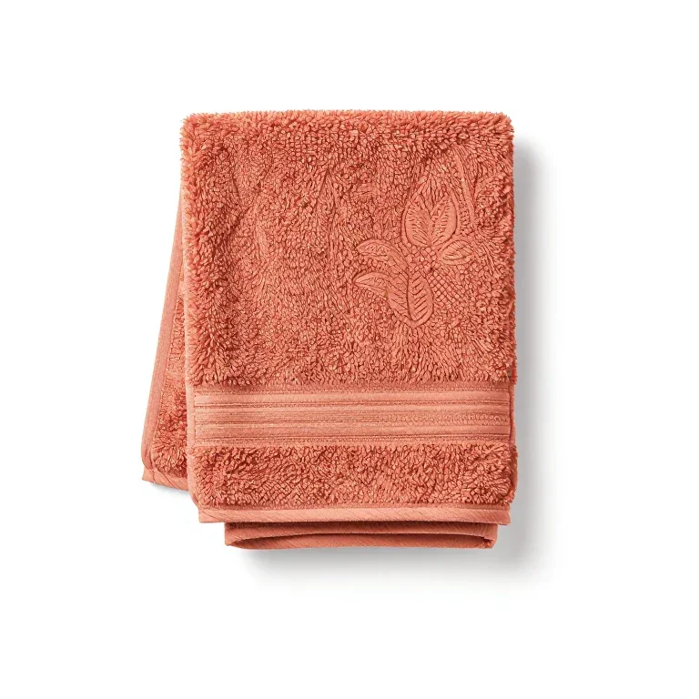 a folded bath towel in terracotta, three-quarter view, single item fully visible and centred,...
