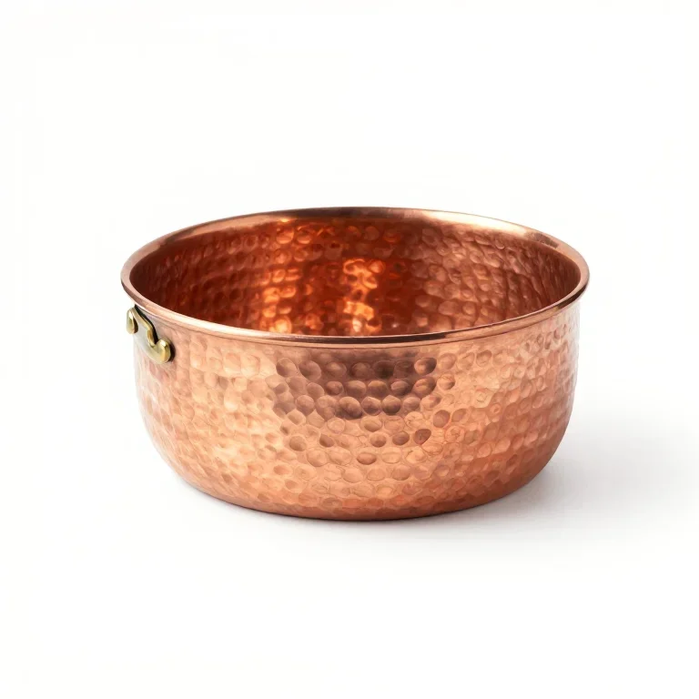 a hammered copper saucepan, three-quarter view, single item fully visible and centred, isolat...