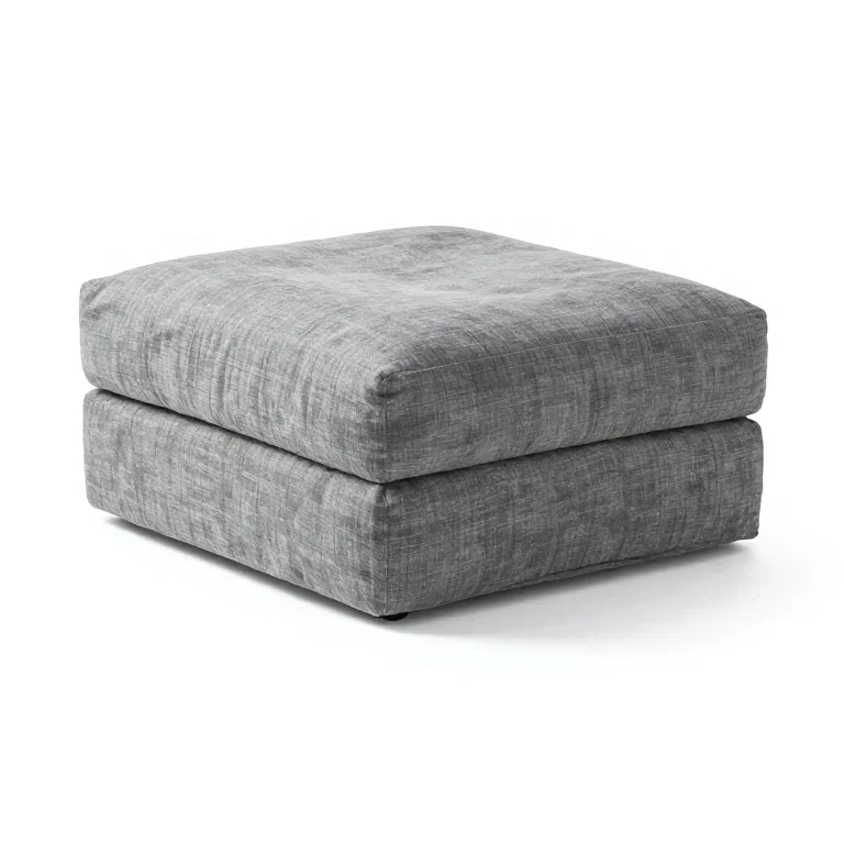 a padded footstool in grey linen, three-quarter view, single item fully visible and centred,...