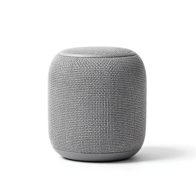a portable bluetooth speaker in woven fabric, three-quarter view, single item fully visible a...