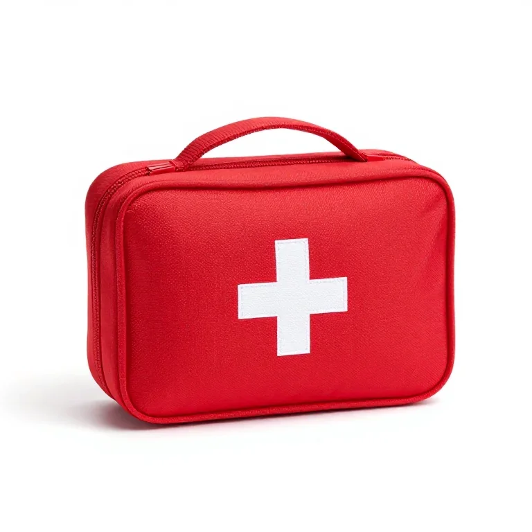 a red zip case first aid kit, three-quarter view, single item fully visible and centred, isol...