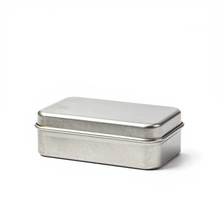 a small tin wind-up music box, side view, single item fully visible and centred, isolated on...