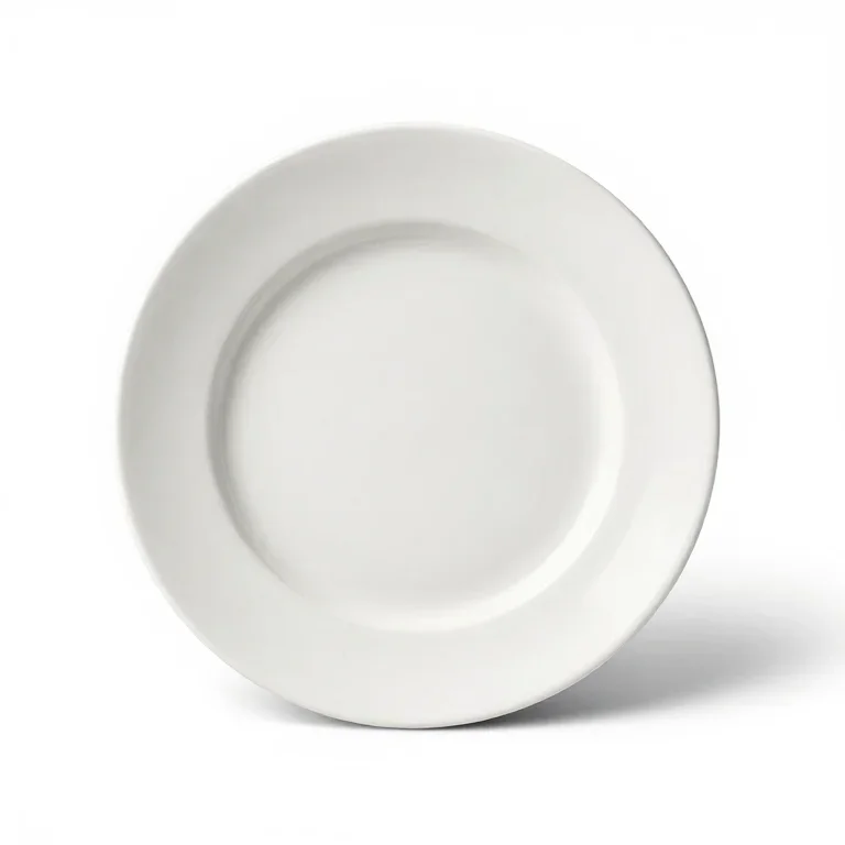a white porcelain dinner plate, high three-quarter view, single item fully visible and centre...