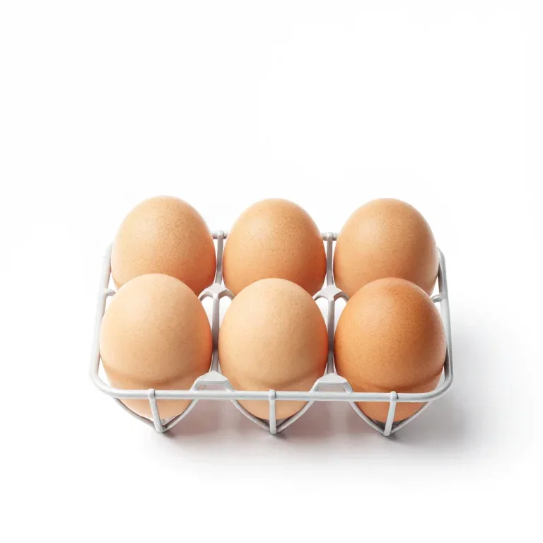 a wire egg tray holding six eggs, top-down view, single item fully visible and centred, isola...