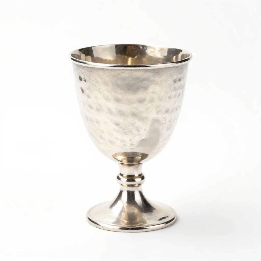 Goblet of hammered silver isolated on a white background