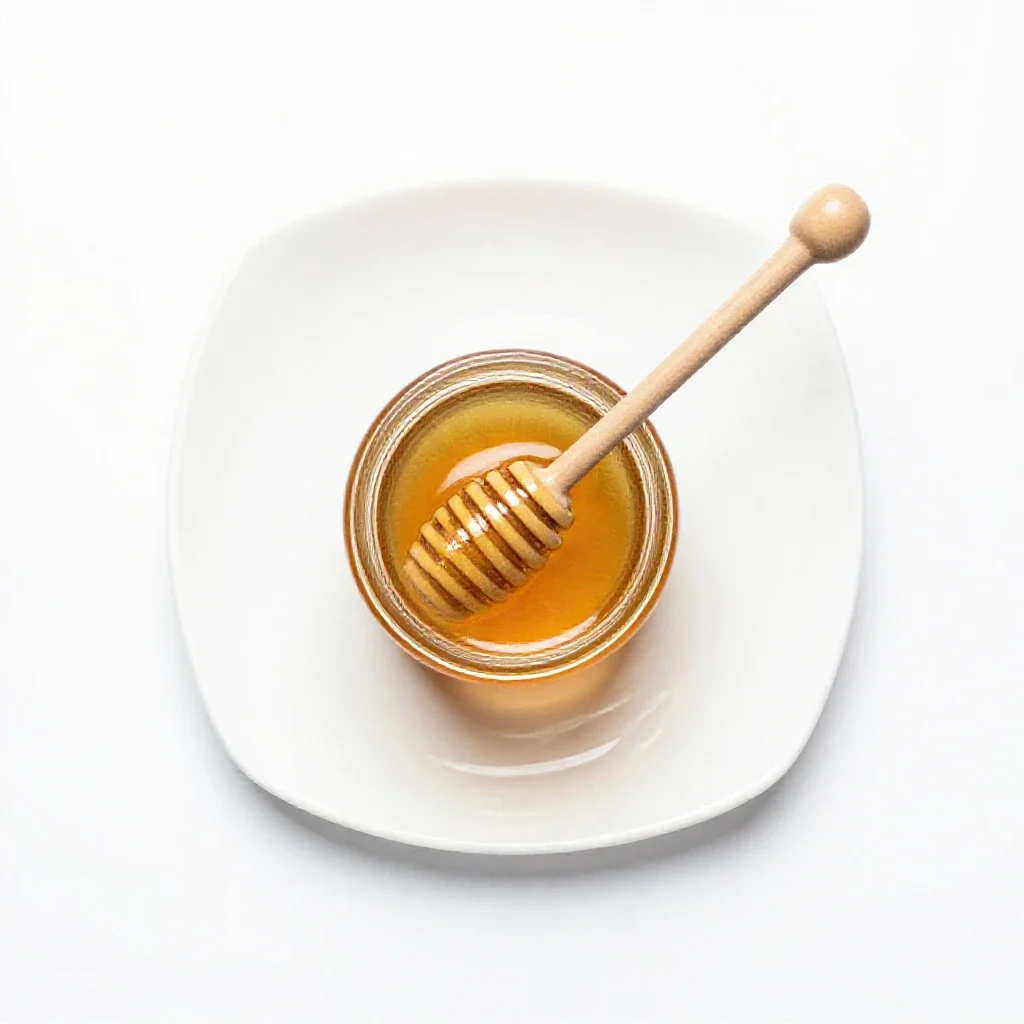Jar of honey with a dipper isolated on a white background