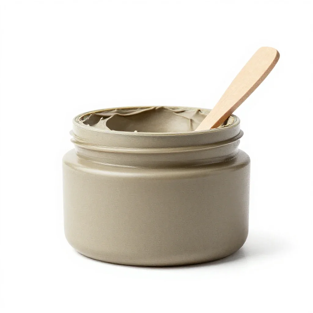 Clay mask jar with a spatula isolated on a white background