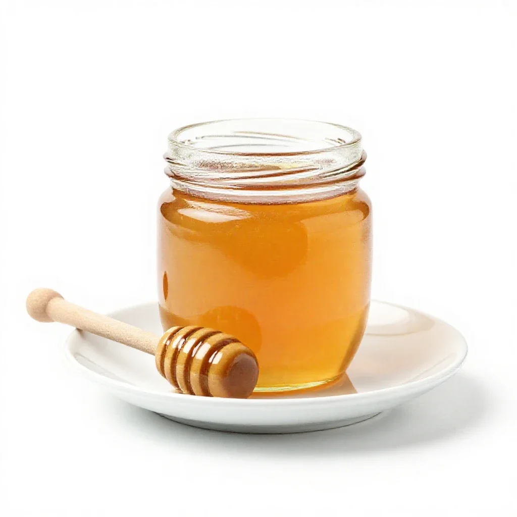 Jar of honey with a dipper isolated on a white background