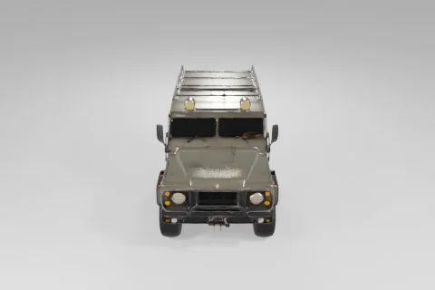 Rugged green military-style off-road vehicle stands on thick tires, equipped 3D model preview
