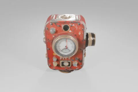 Red, weathered mechanical device featuring a large central gauge, brass 3D model preview