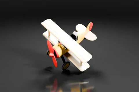 Yellow and beige toy biplane with red propeller and tail fin 3D model preview